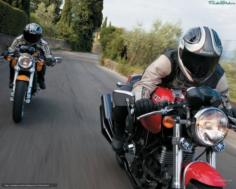 Two riders on Ducati motorcycles