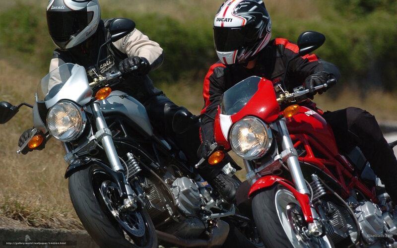 Two riders on Ducati motorcycles
