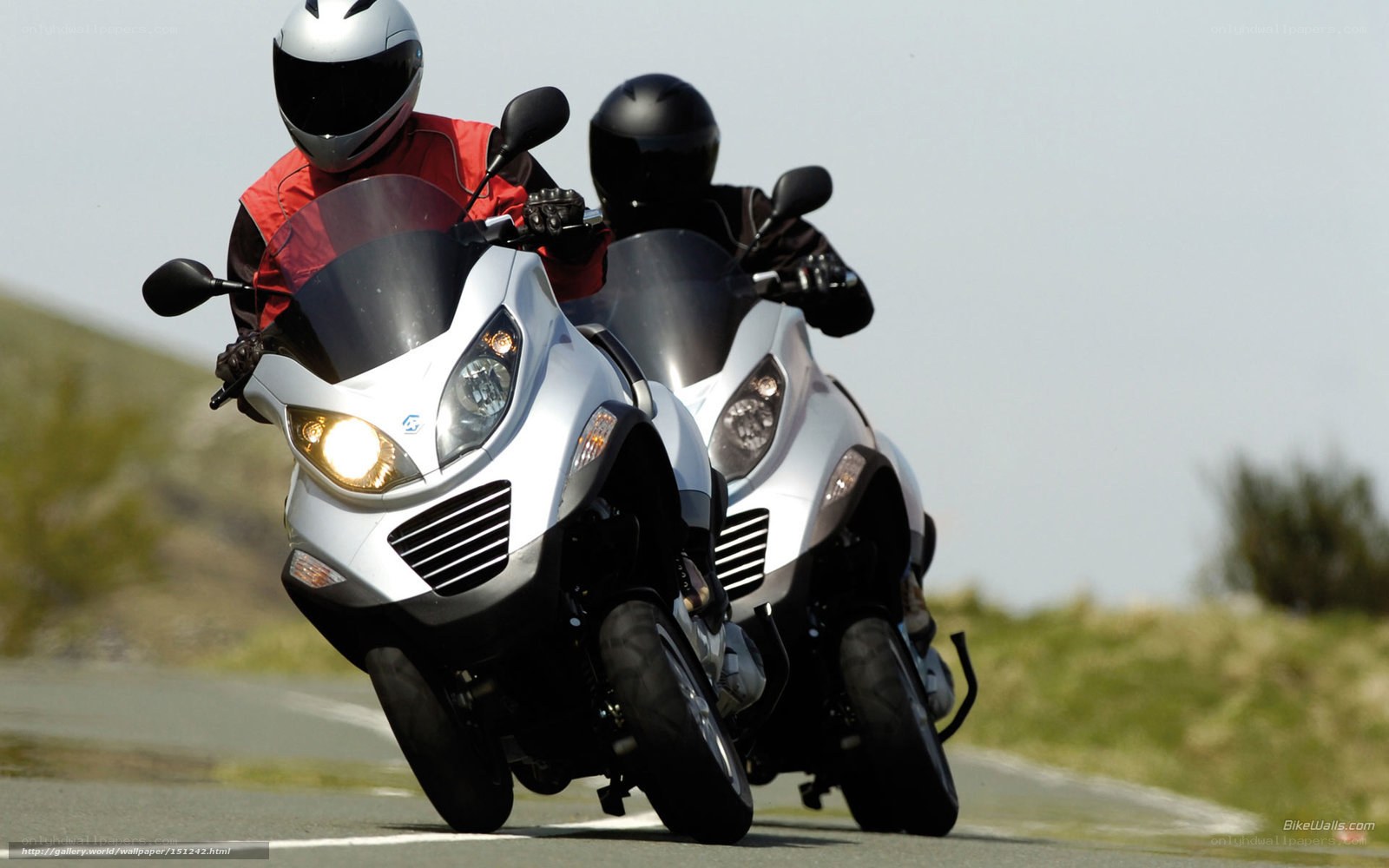 Two riders on scooters