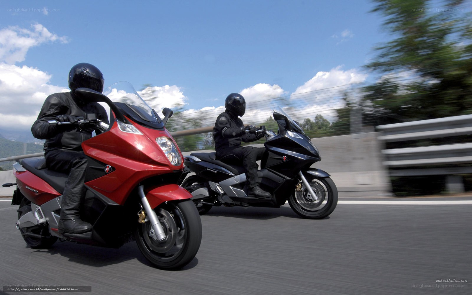 Two riders on scooters