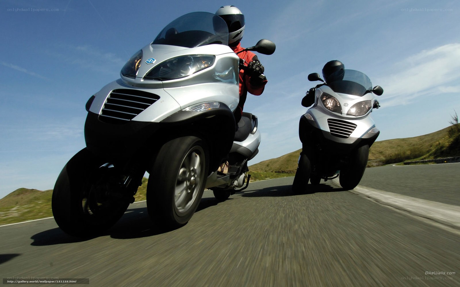 Two riders on silver trikes