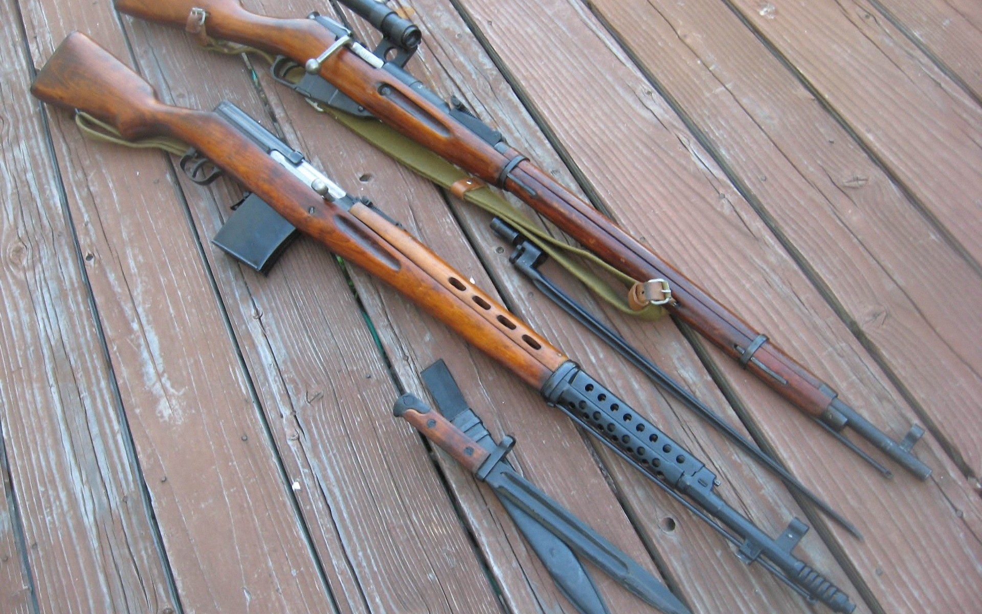 Two rifles on wooden deck