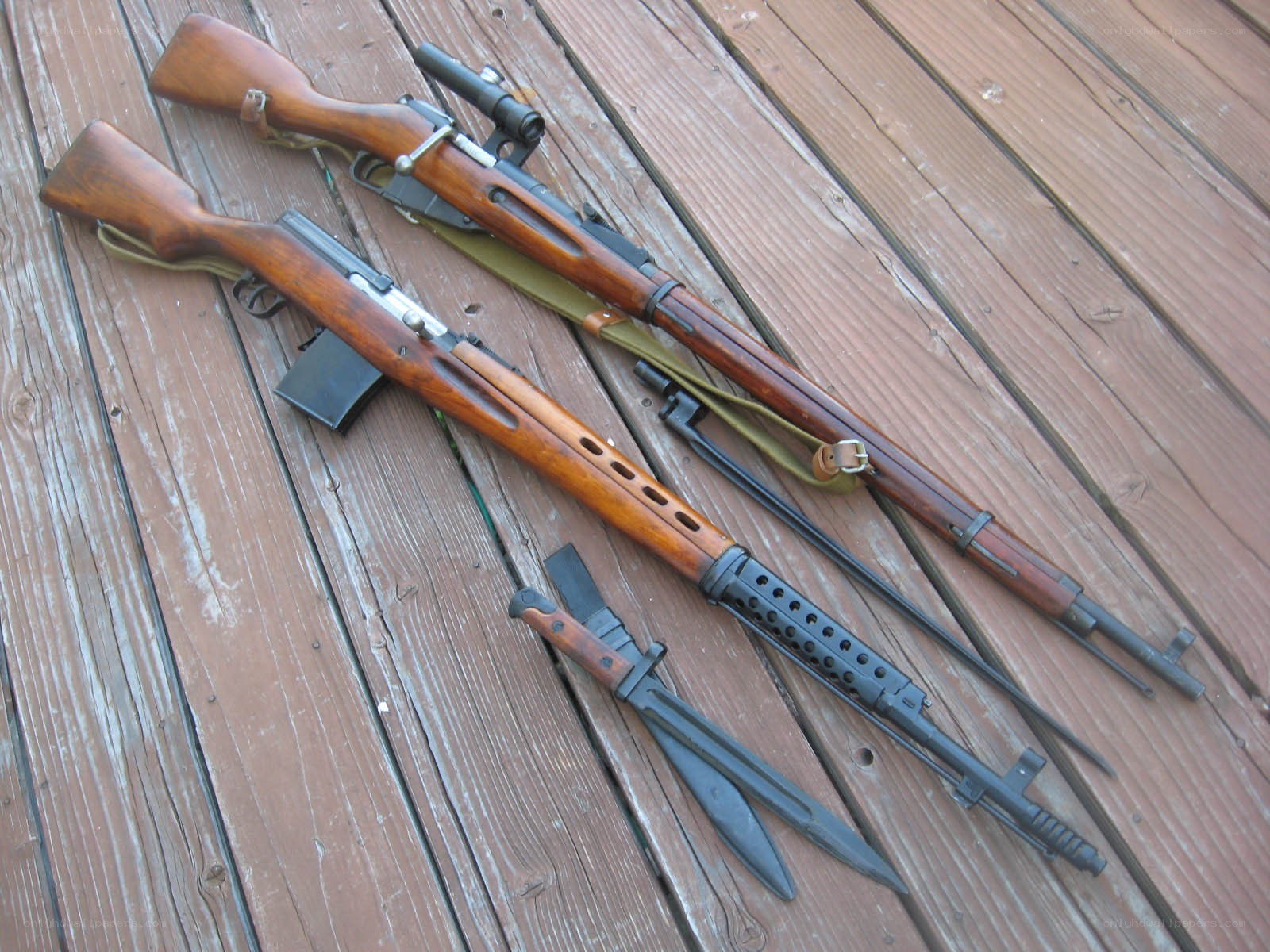 Two rifles on wooden deck