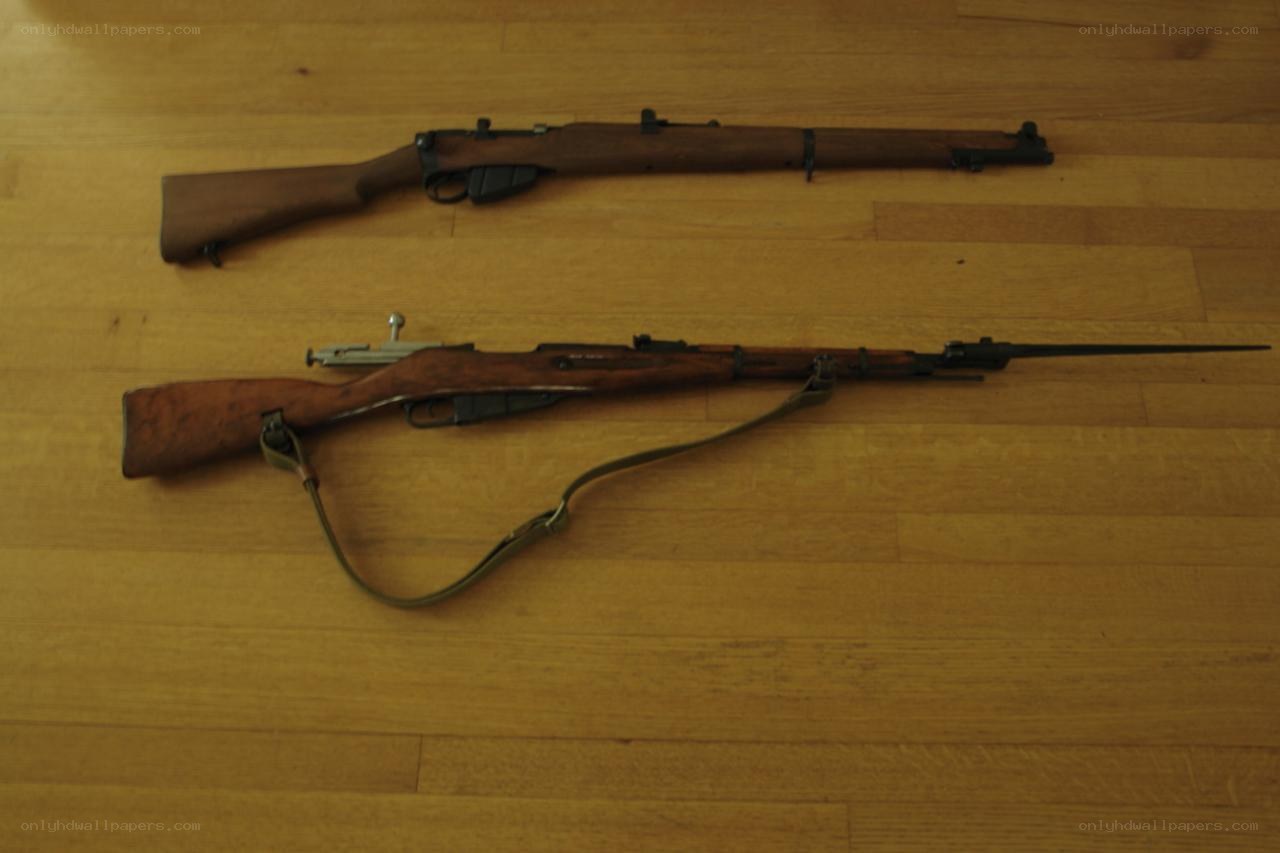 Two rifles on wooden floor