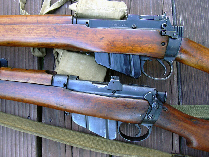 two rifles on wooden surface