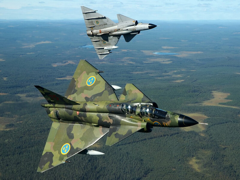 Two Saab fighter jets in flight