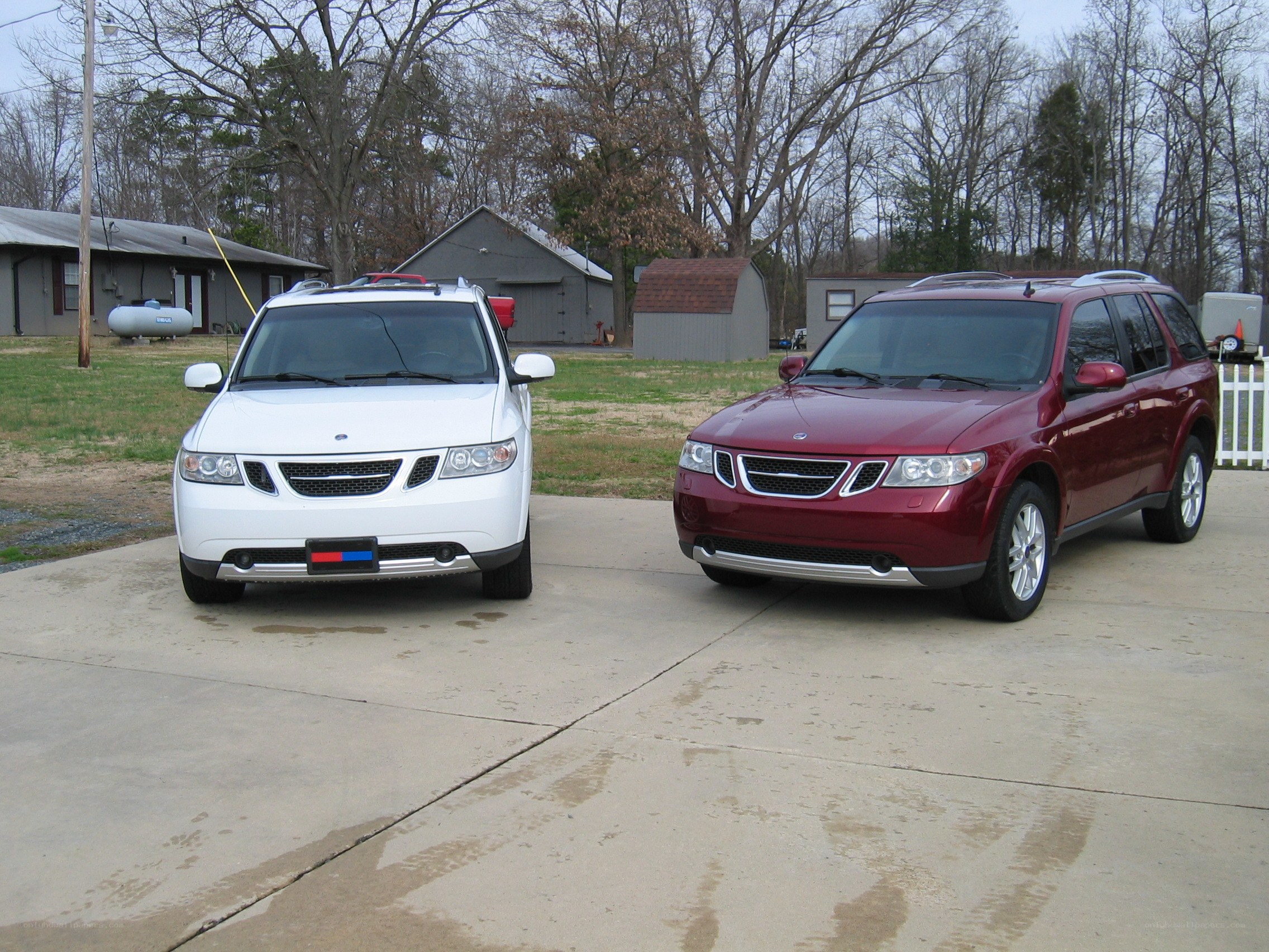 Two Saab SUVs on a driveway