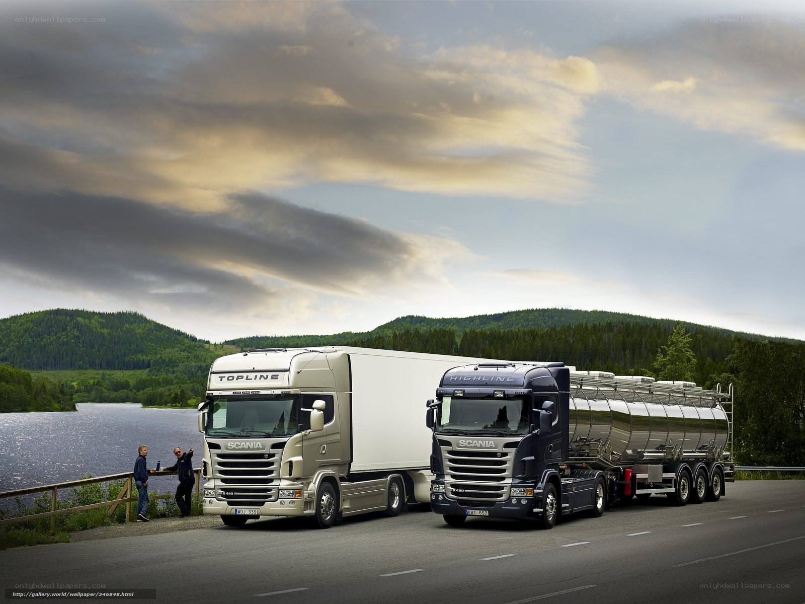 Two Scania trucks on a scenic road