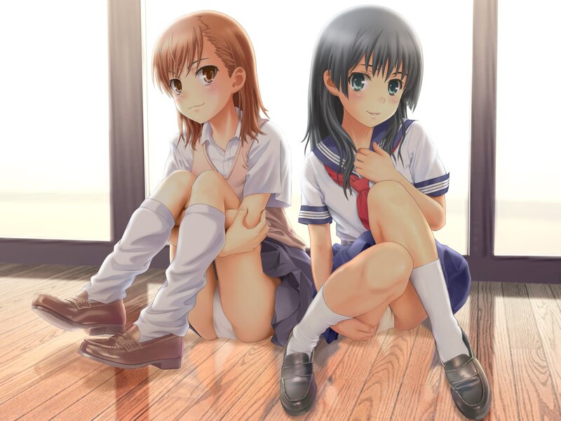 Two schoolgirls sitting on floor