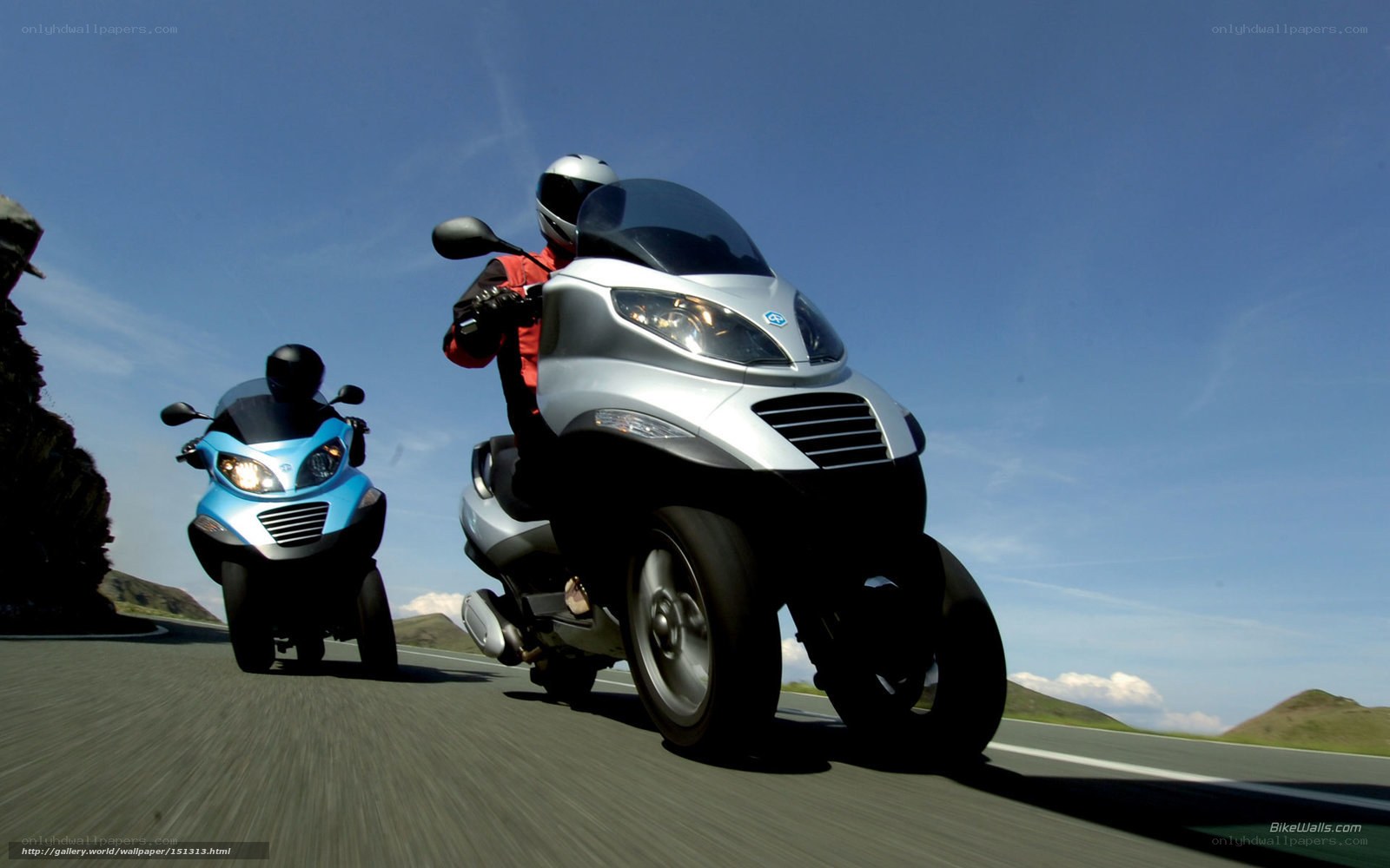 Two scooters on a road