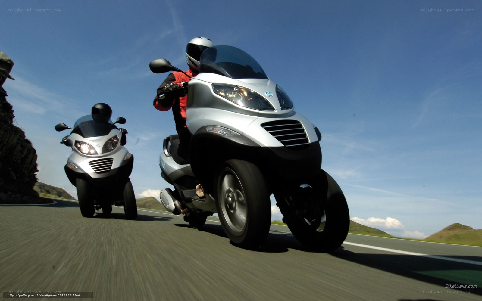 Two scooters on a winding road