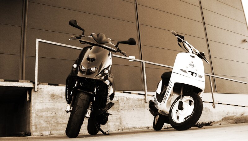 Two scooters parked outside