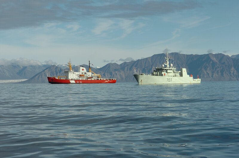 Two ships in a mountainous bay