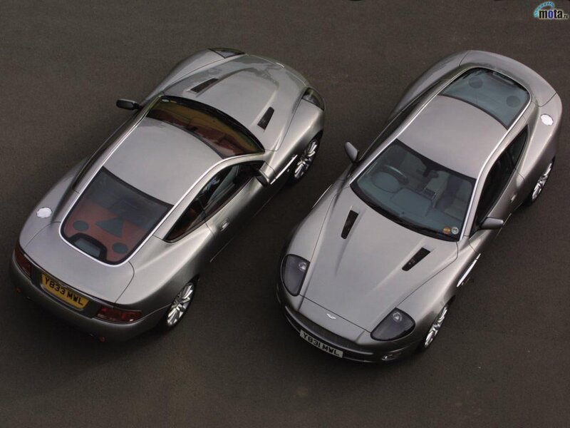 Two silver Aston Martin cars