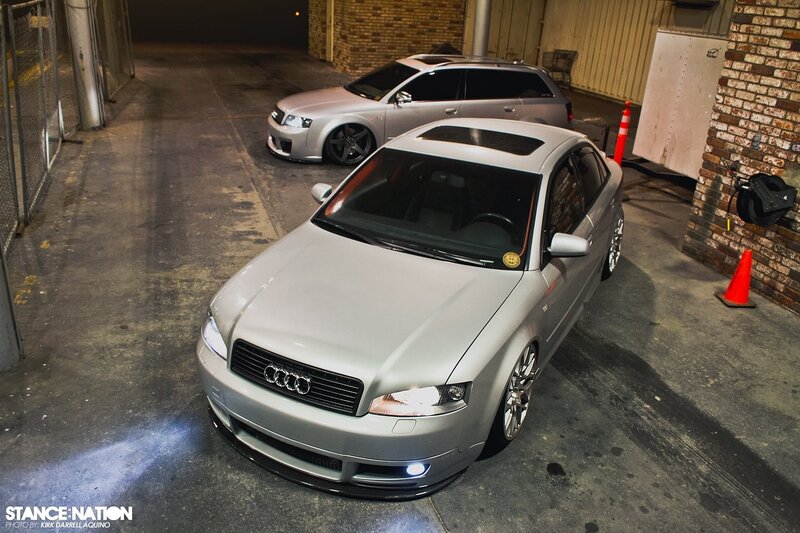 Two silver Audi cars in a garage