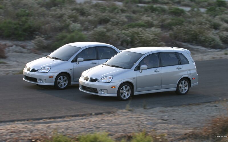Two silver cars on a road