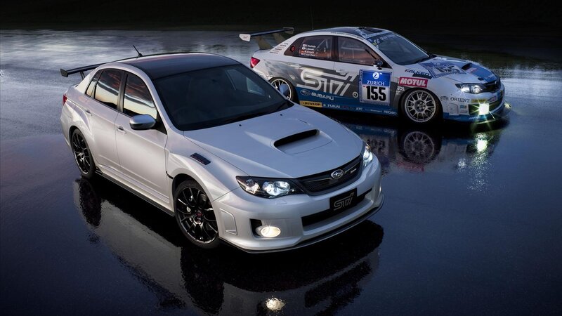 Two Silver Cars on Wet Pavement
