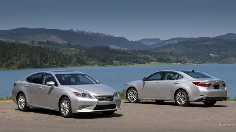 Two silver Lexus cars by a lake