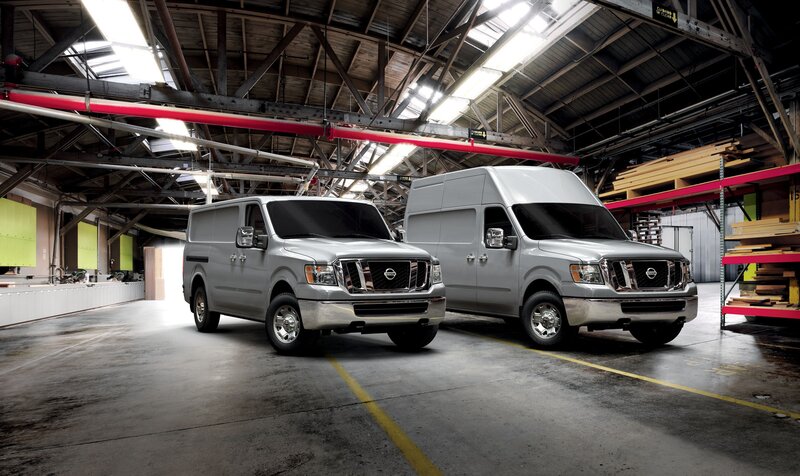 Two silver vans in a warehouse