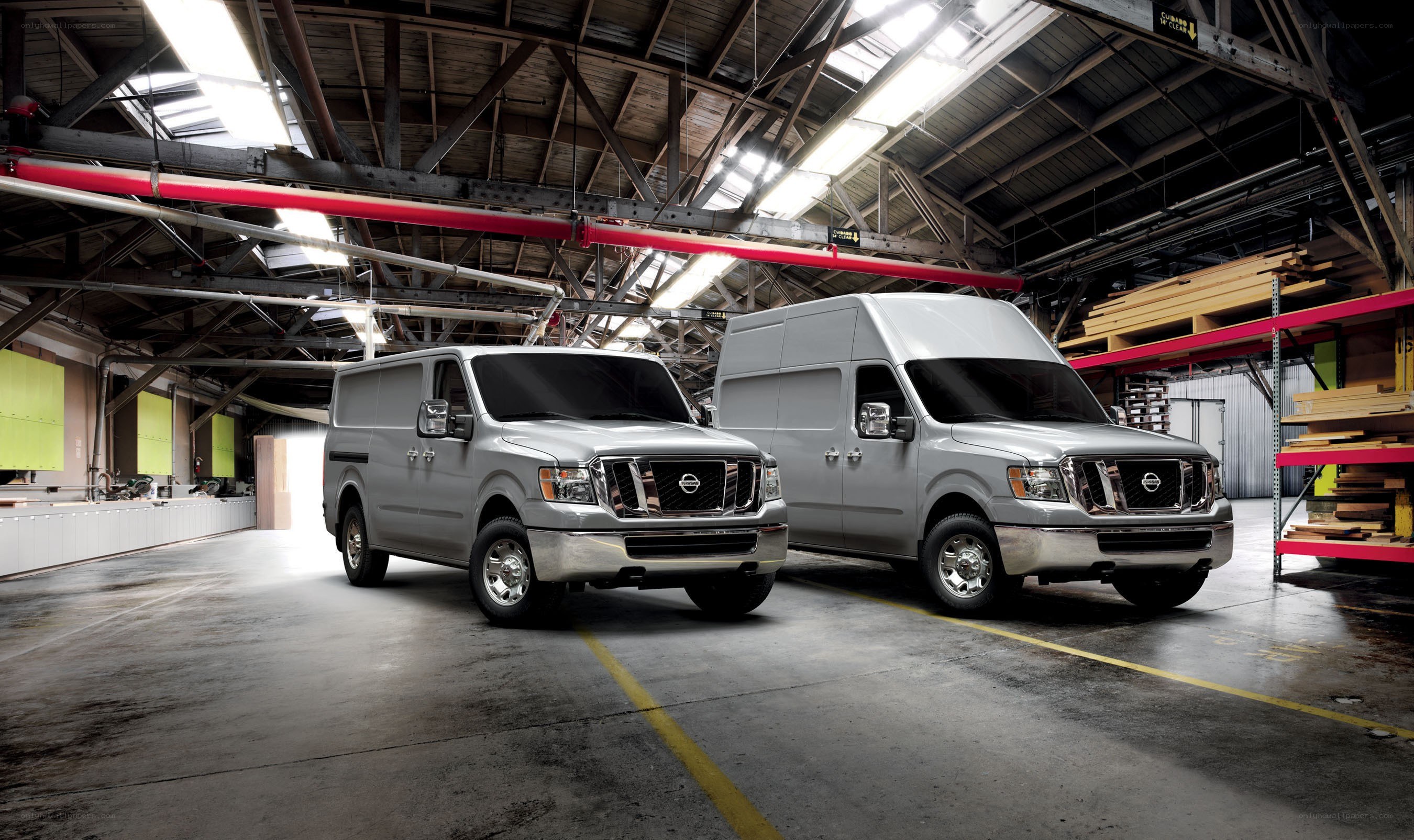 Two silver vans in a warehouse