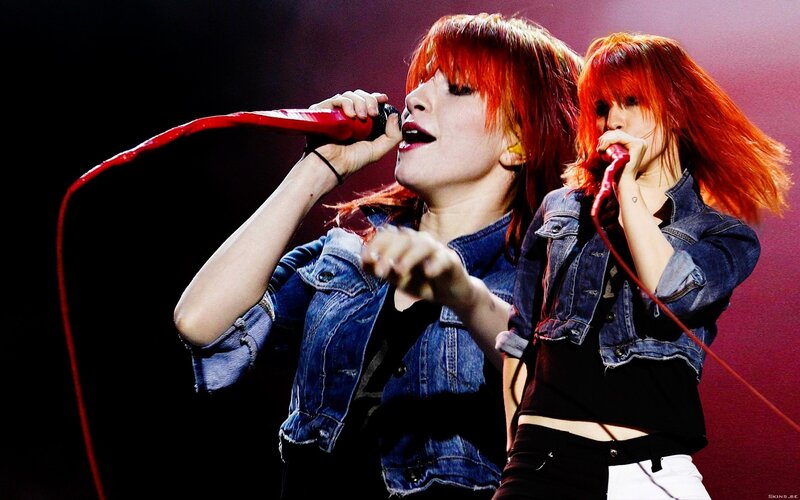 Two singers performing on stage