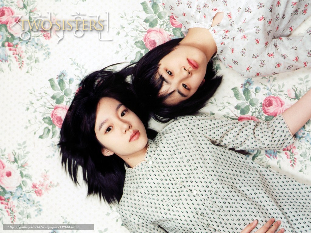 Two sisters lying on bed