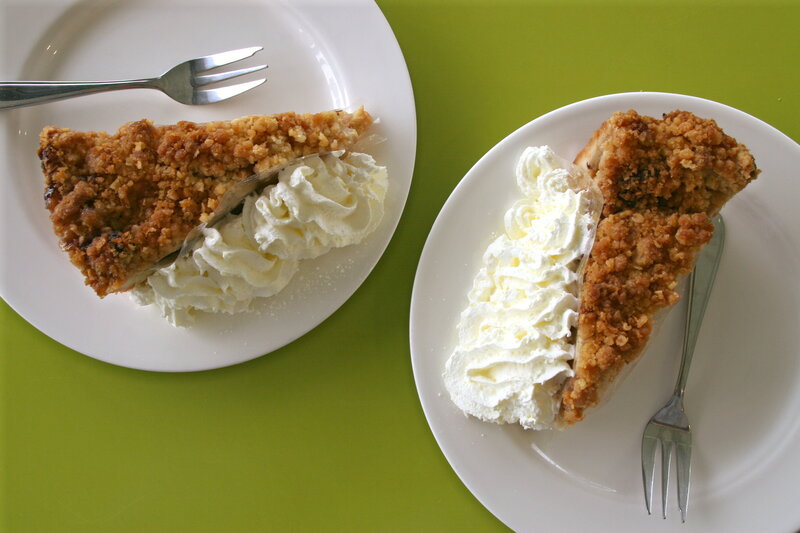 Two slices of pie with whipped cream