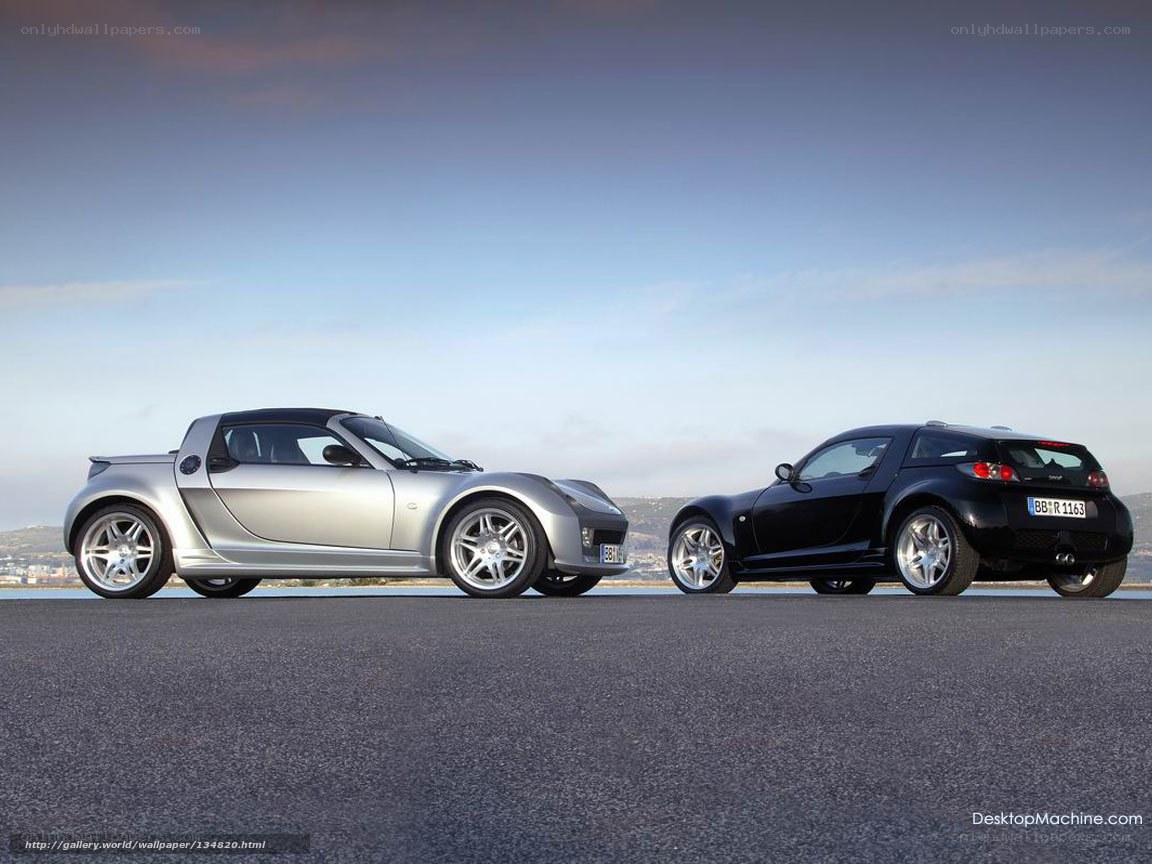 Two Smart Roadsters on a coastal road