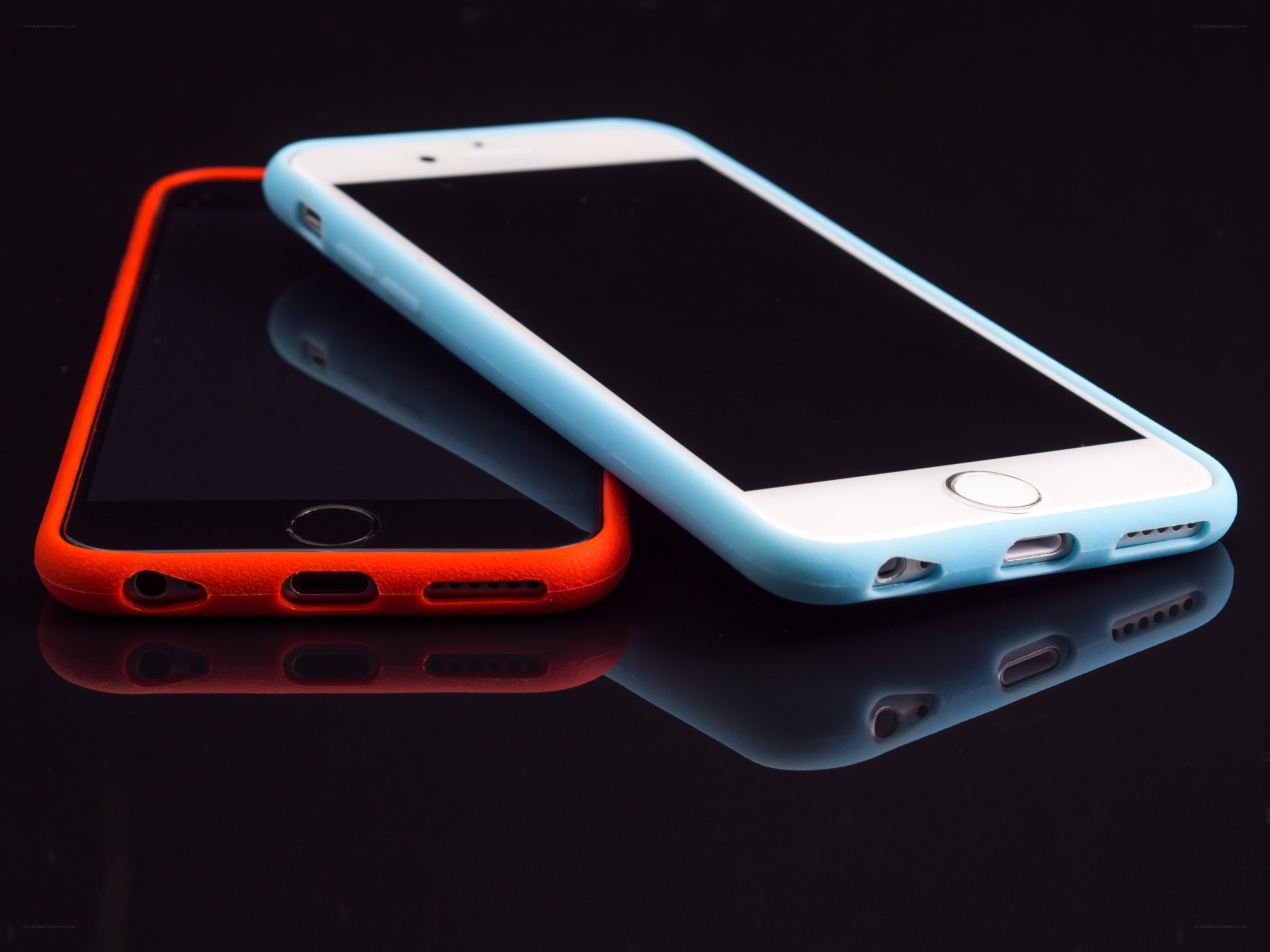 Two smartphones in colorful cases