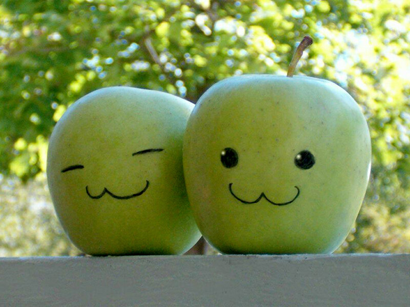 Two smiling apples