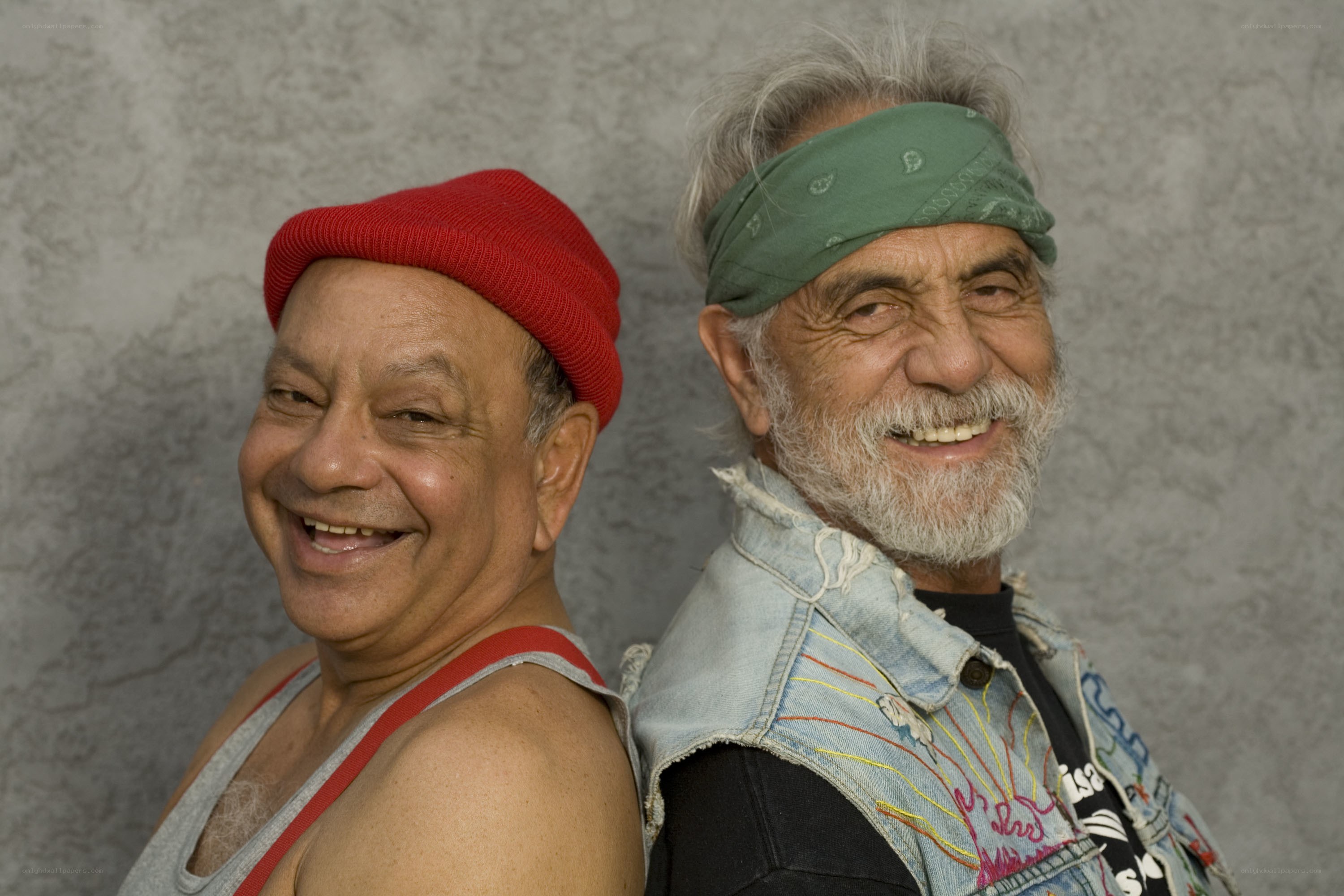Two smiling men in headwear