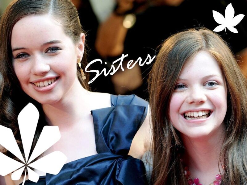 two smiling sisters at event