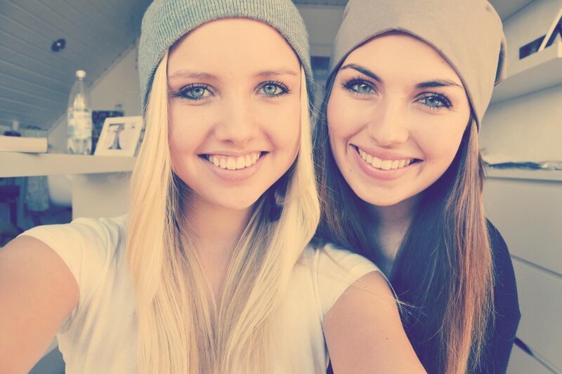 Two smiling women in beanies