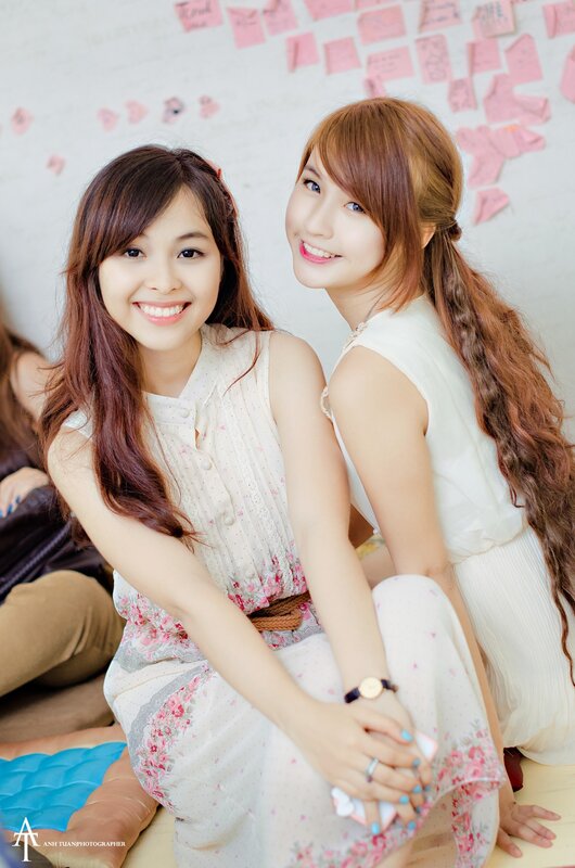 Two smiling women in floral dresses