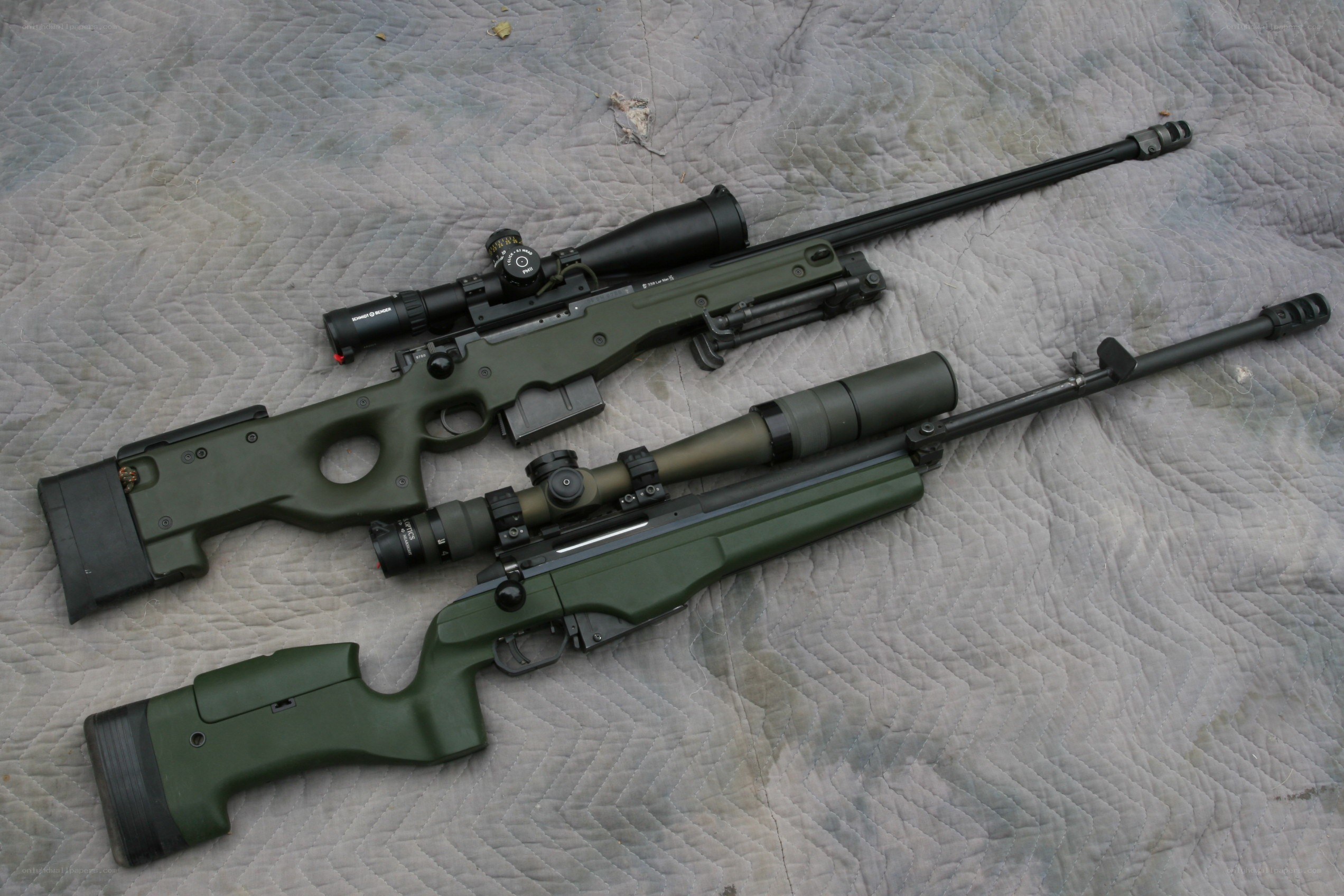 Two sniper rifles on a quilt