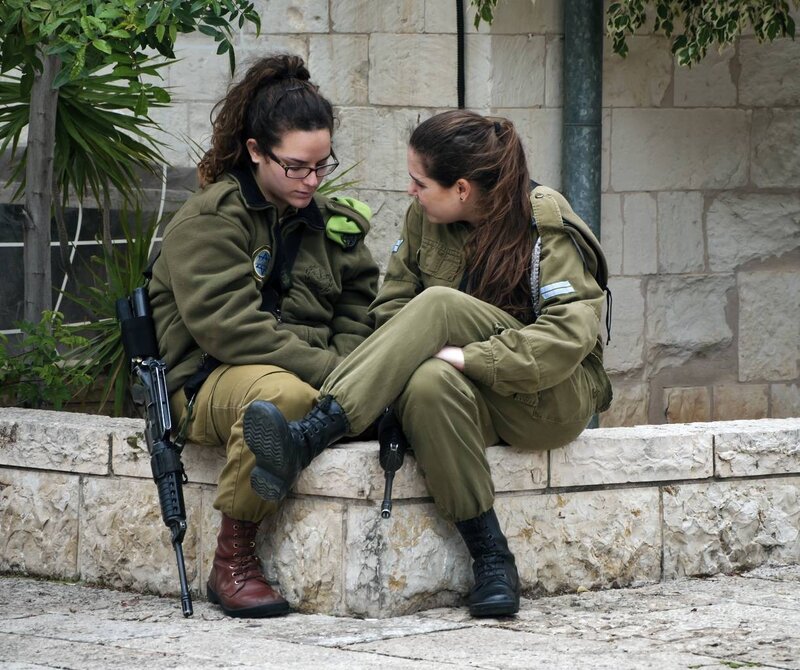 Two soldiers talking on a wall