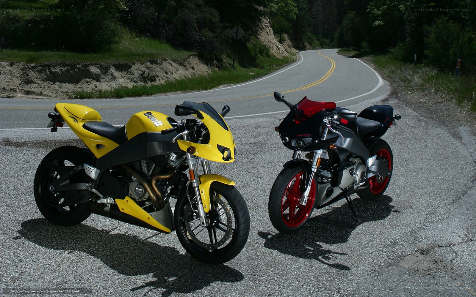 Two sport motorcycles on a road