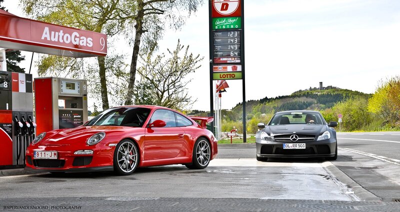 Two sports cars at a gas station