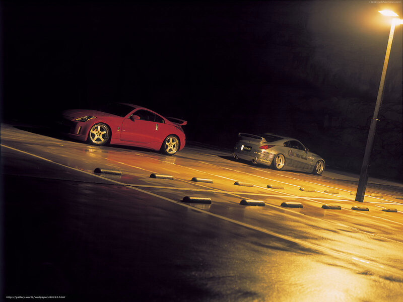 Two sports cars at night