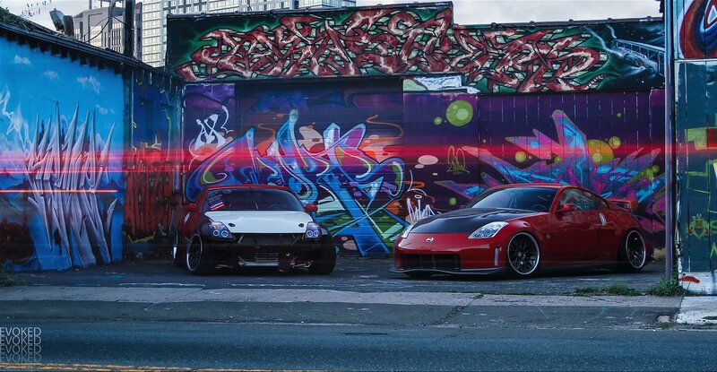 Two sports cars in a graffiti alley