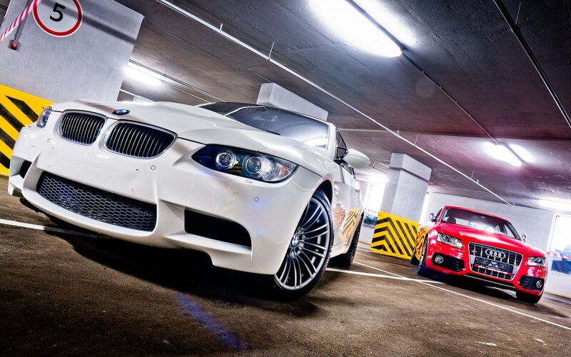 Two sports cars in a parking garage