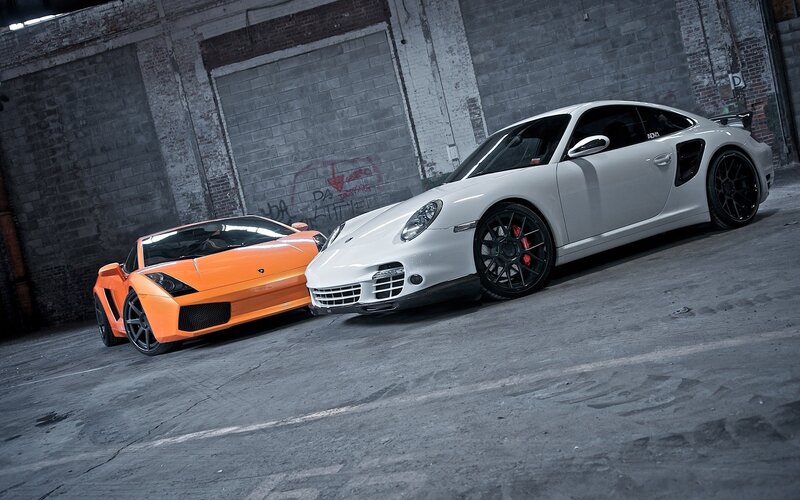 Two sports cars in a warehouse