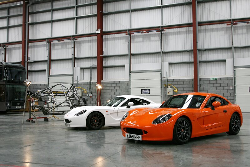 Two sports cars in a workshop