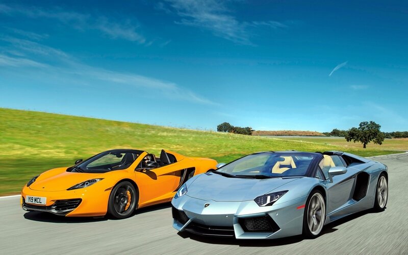 Two sports cars on a road