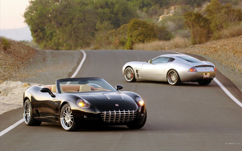 Two sports cars on a winding road
