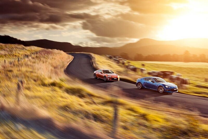 Two sports cars on a winding road