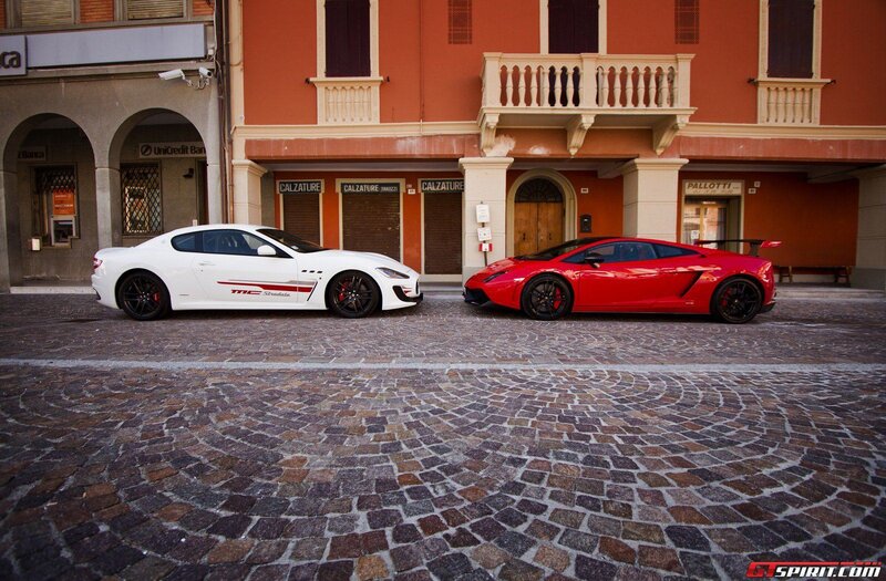 Two sports cars on cobblestones