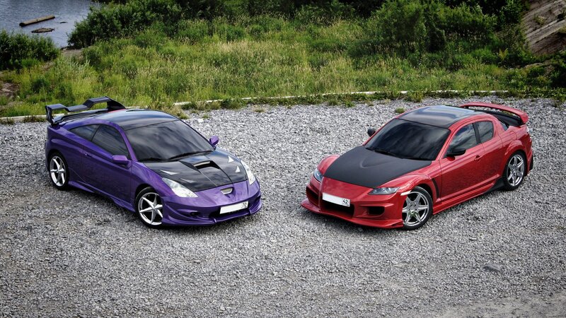 Two sports cars on gravel