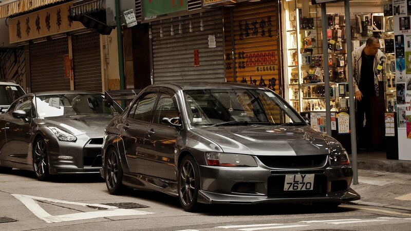 Two sports cars parked on a street