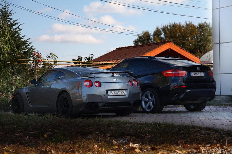 Two sports cars parked outside